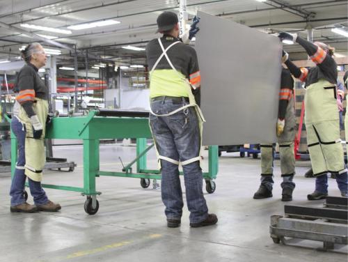 A group of new Viracon, viracon.com, employees being taught how to safely handle and lift glass. 