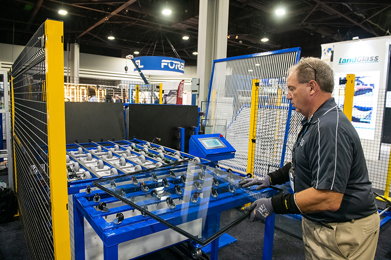 Worker handling glass from auto-loading system