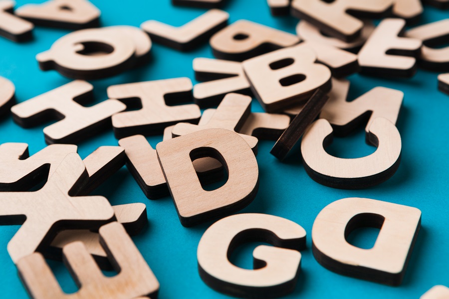 graphic of wooden letters jumbled on a surface