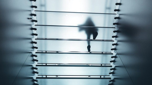 person walking on glass floor