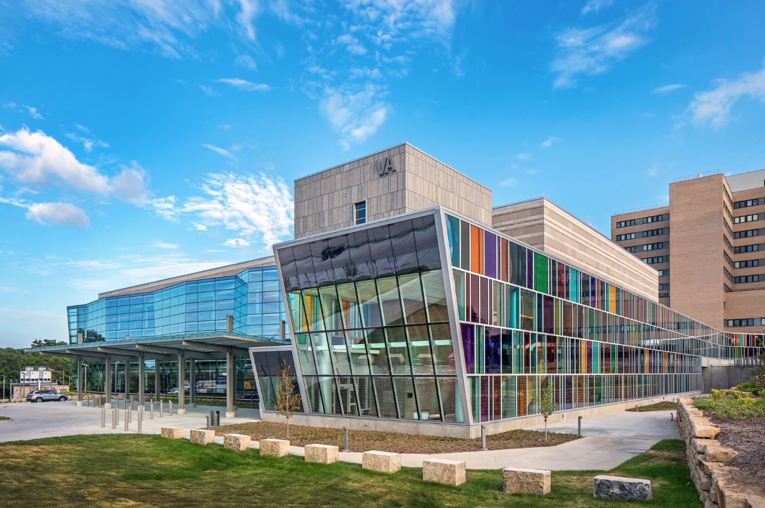 multi-color glass façade with sloped wall on one end