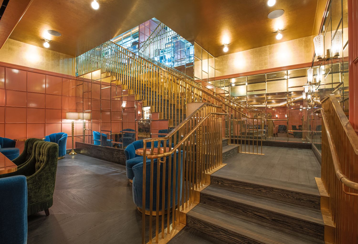 mosaic of mirrors lines a three-level staircase that connects hotel lobby to a nightclub