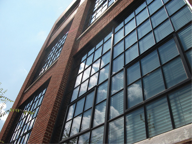 brick building with narrow, black trimmed window systems