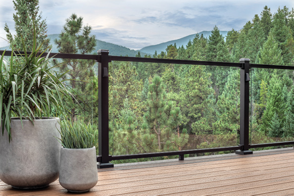 View of mountains through glass deck railing