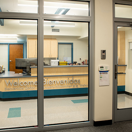 an interior photo of a glass entrance and wall using a fire-rated bullet-resistant glass system in a school