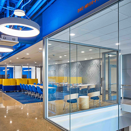 an interior photo of a meeting room with a glass partition in the foreground made of TGP’s Fireframes ClearView® System 