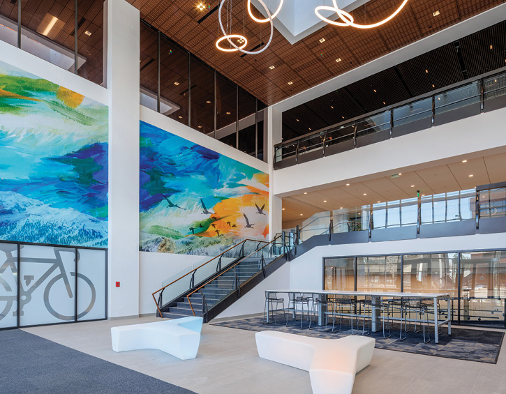 building entrance with glass stairs and mural