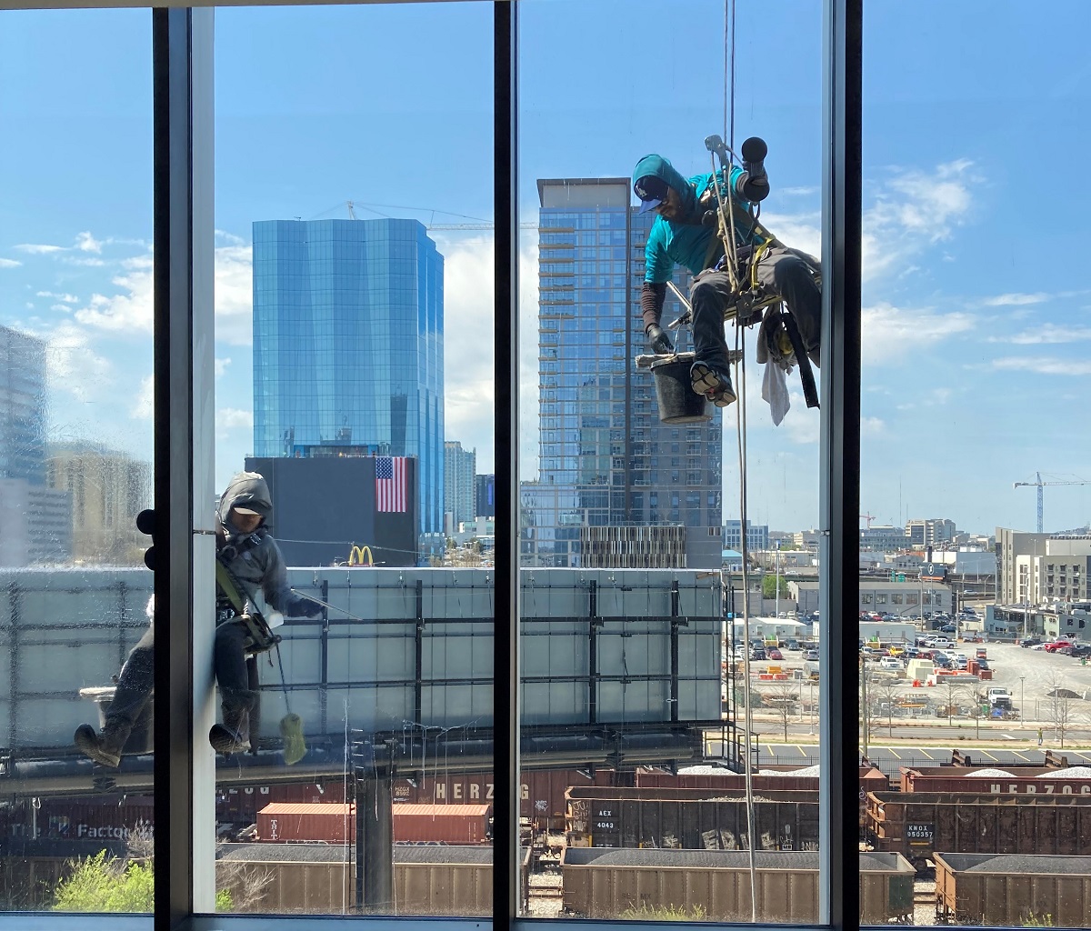 glass installers clean glass on a jobsite