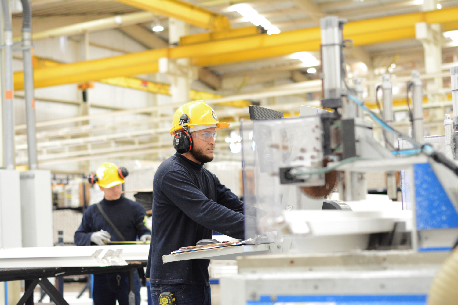 two workers on fabrication line