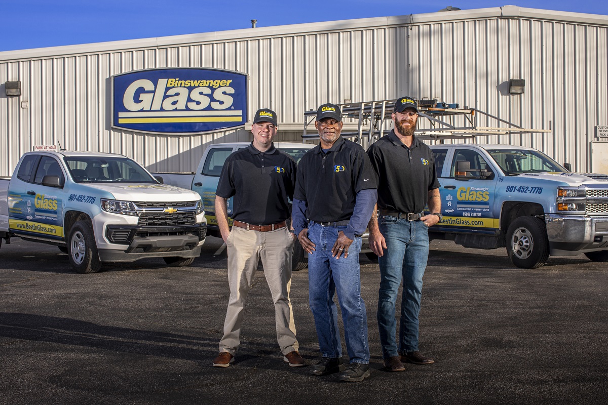 Binswanger employees stand in front of Binswanger glass trucks