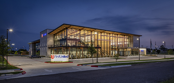 Expansive curtain wall effectively wraps around the building for a monolithic facade