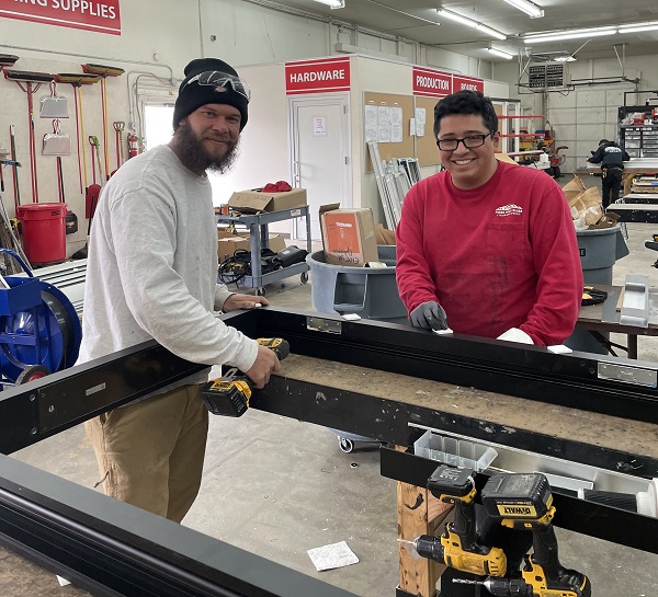 apprentices working on a glazing unit at city glass