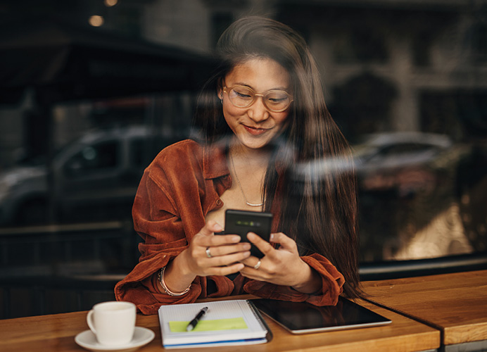 young woman working with phone and notebook