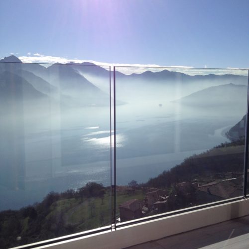 glass railing with mountains in background