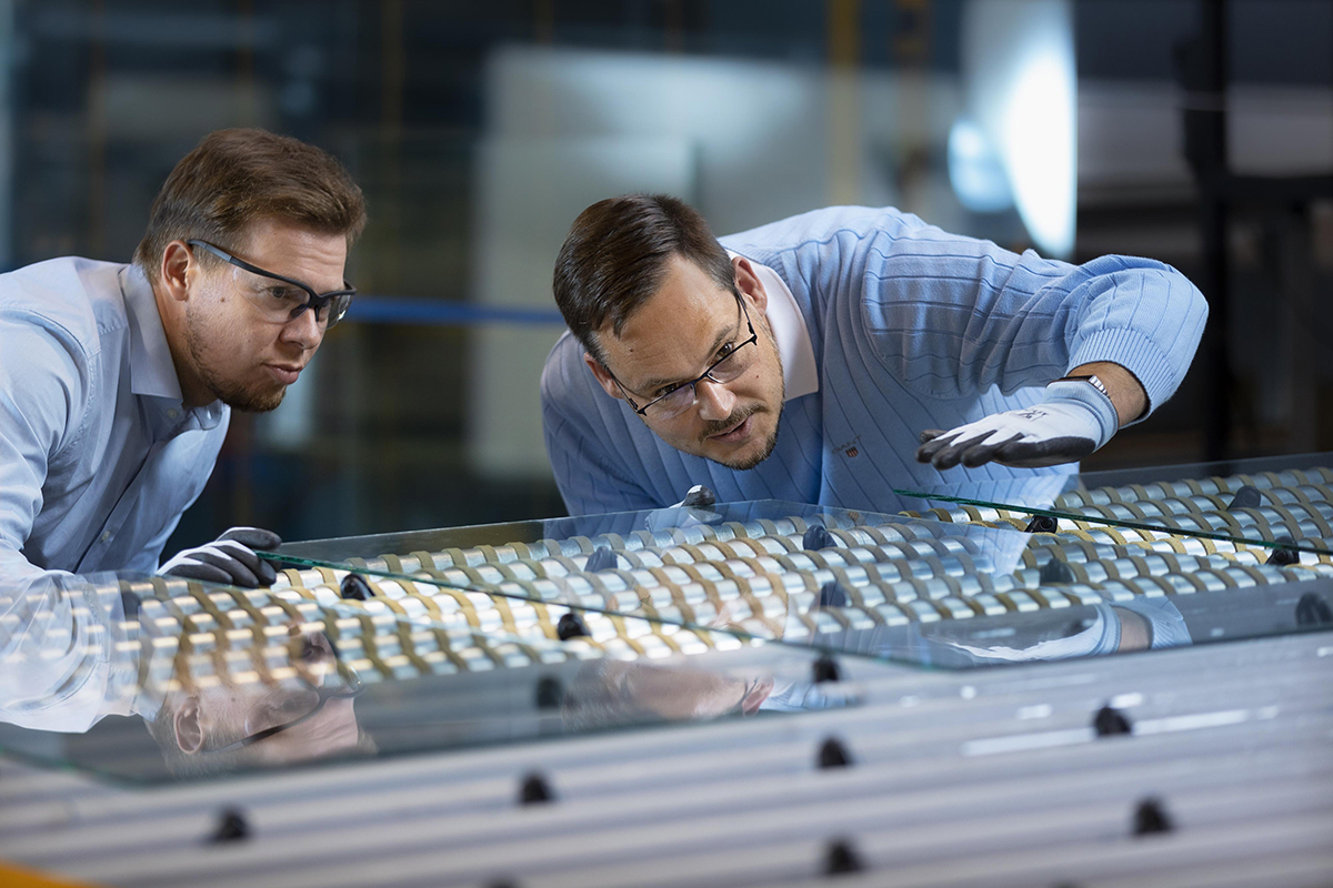 Men inspecting glass