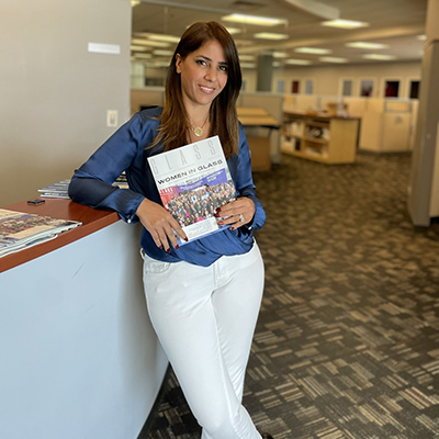 Qaimari holding up Glass Magazine's Women in Glass issue