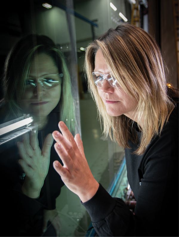 employee inspects glass at the factory