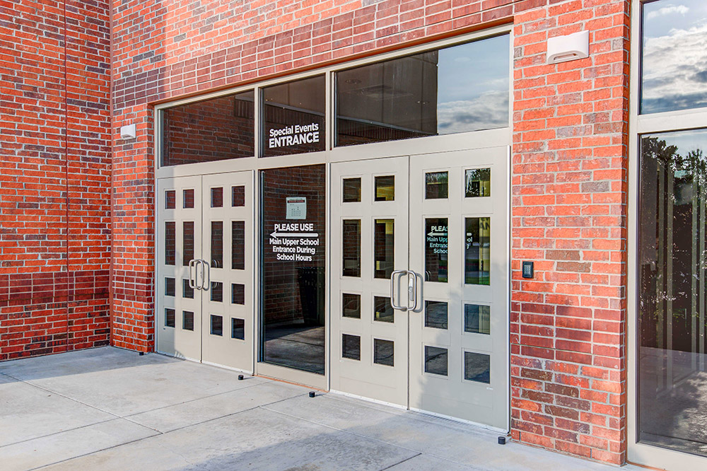Custom doors and entrance systems with an antique bronze painted finish were selected by AVL Systems Design and installed by George Knox Glass on Crossings Christian School in Oklahoma City. Photo by Daybreak Pics.