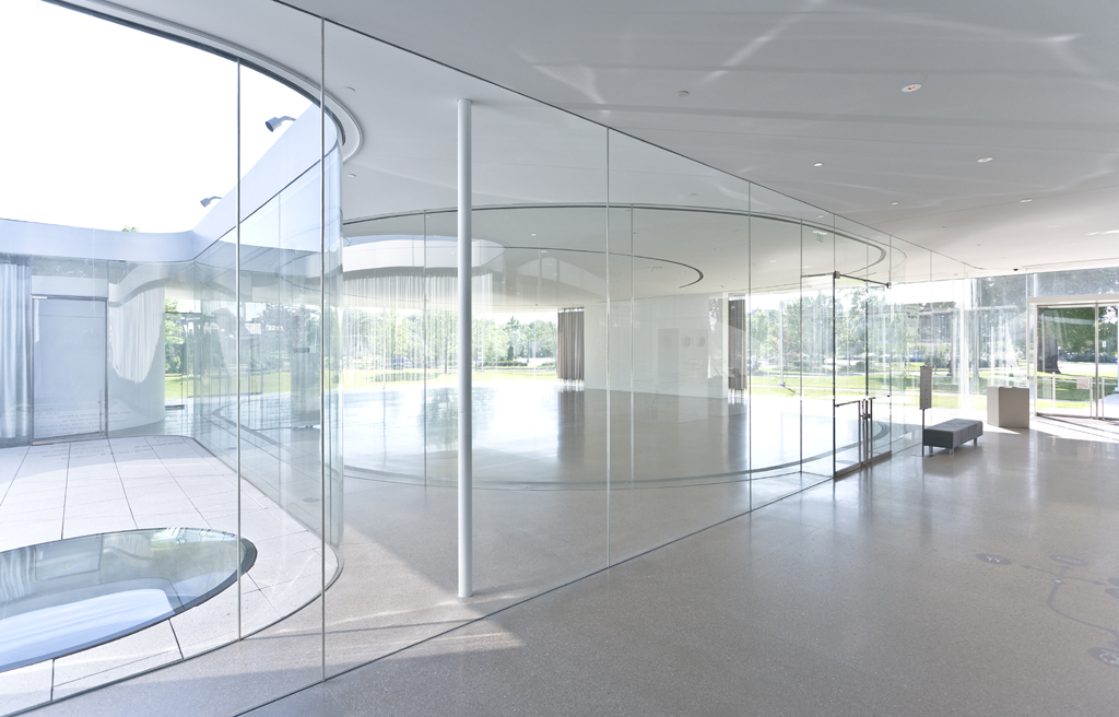 interior of a building overlooking an all glass curved entrance