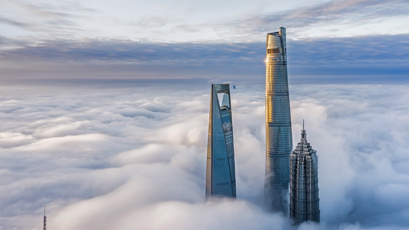 top of three tall buildings above the clouds