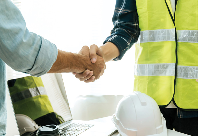 handshake between construction worker and business man