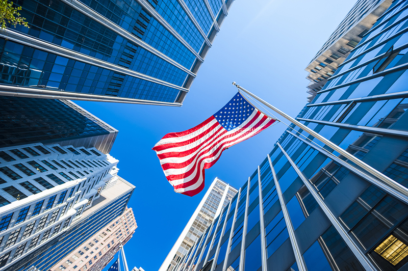 Flag in the middle of glass buildings