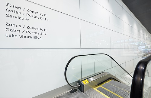 white painted glass in escalator corridor