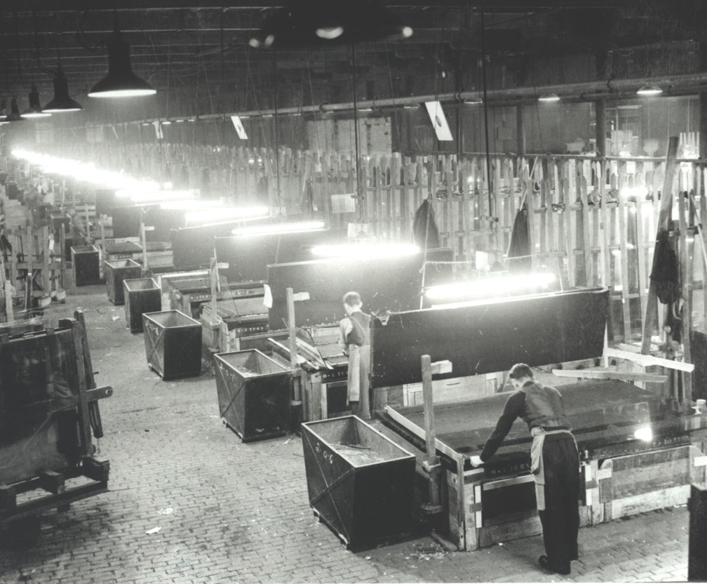 Workers polishing glass at individual cutting tables
