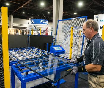 Worker handling glass from auto-loading system