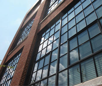 brick building with narrow, black trimmed window systems