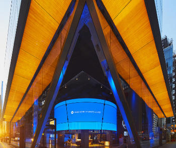 390 Madison Avenue in New York City features a chambered corner that is back-lit wood-grain glass created by GGI Alice direct-to-glass printing