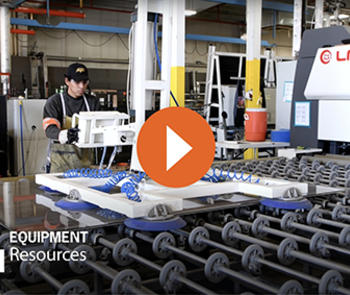 a worker operating the automatic laminated glass production line from hhh equiopment resources with a red play button in the center to activate the video