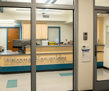 an interior photo of a glass entrance and wall using a fire-rated bullet-resistant glass system in a school
