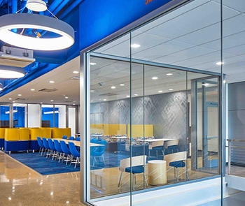an interior photo of a meeting room with a glass partition in the foreground made of TGP’s Fireframes ClearView® System 