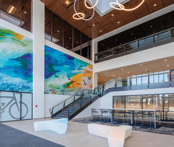 building entrance with glass stairs and mural