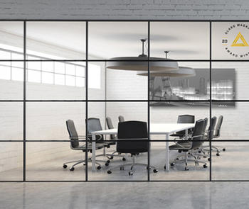 an interior photo looking through a glass partiion to a conference room with table, chairs and large monitor mountted on the wall
